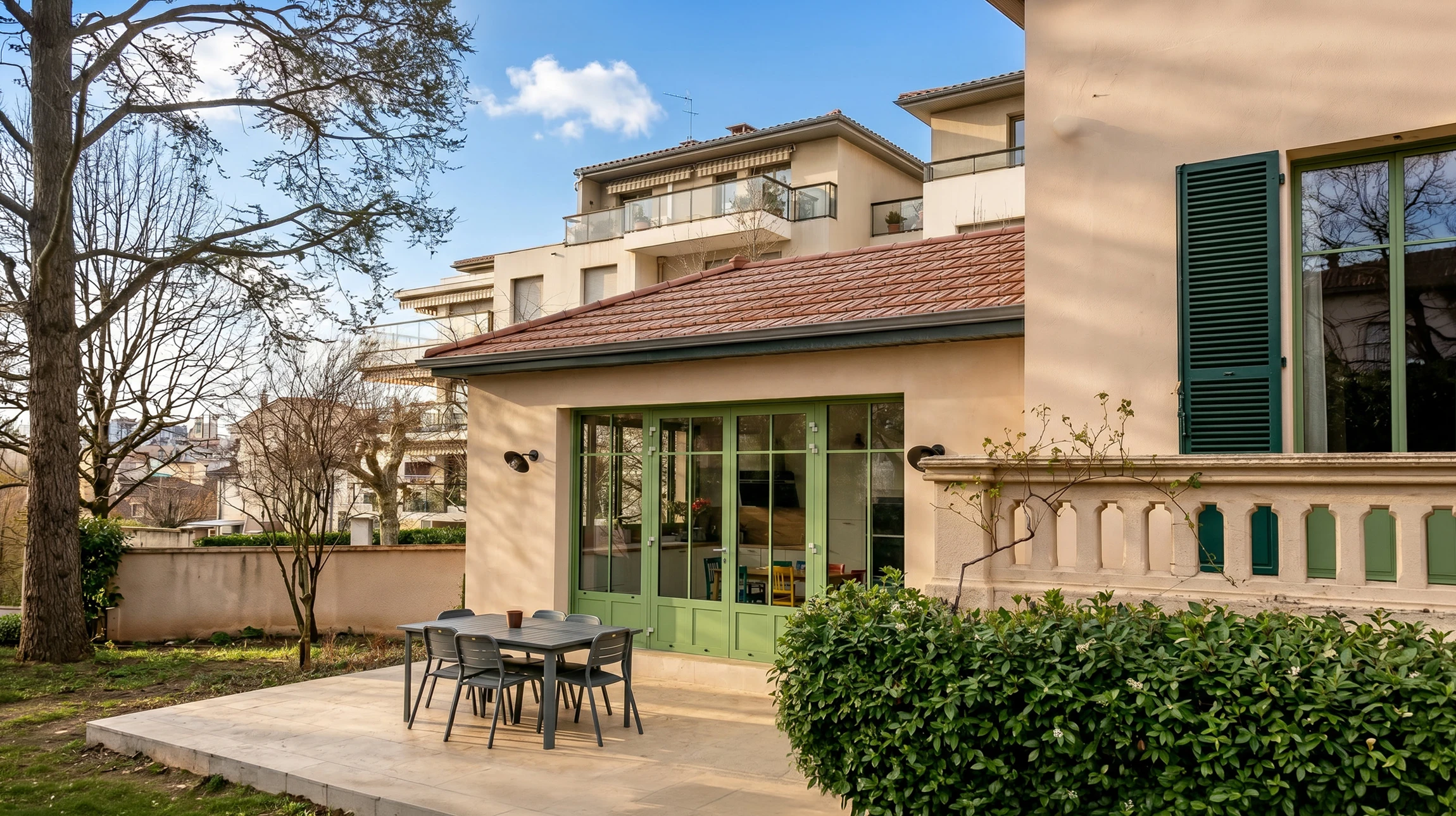 Maison individuelle contemporaine avec extension moderne et garage intégré, située dans un environnement résidentiel verdoyant